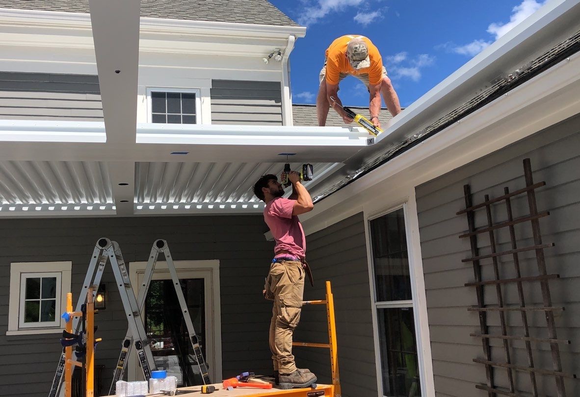 Workers installing a pergola.